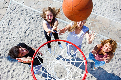 Teens playing basketball